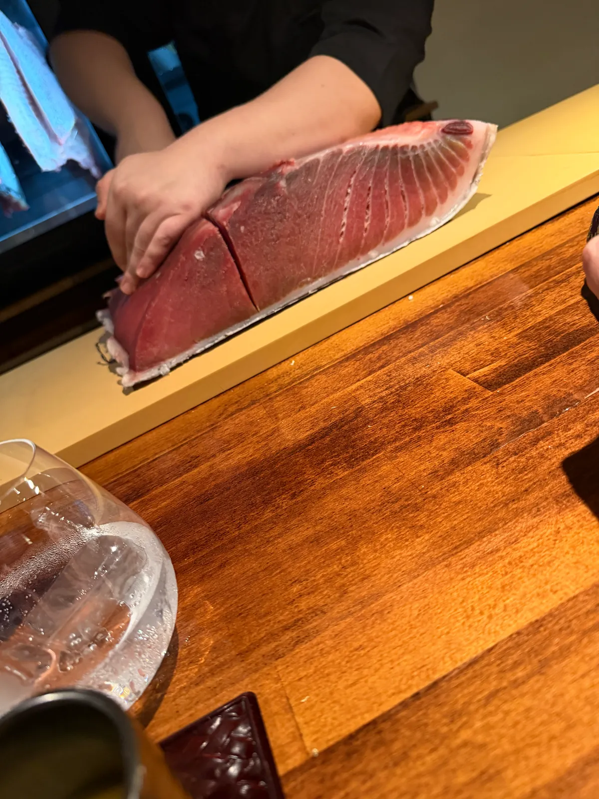 A whole tuna loin carved at an omakase counter in Madrid