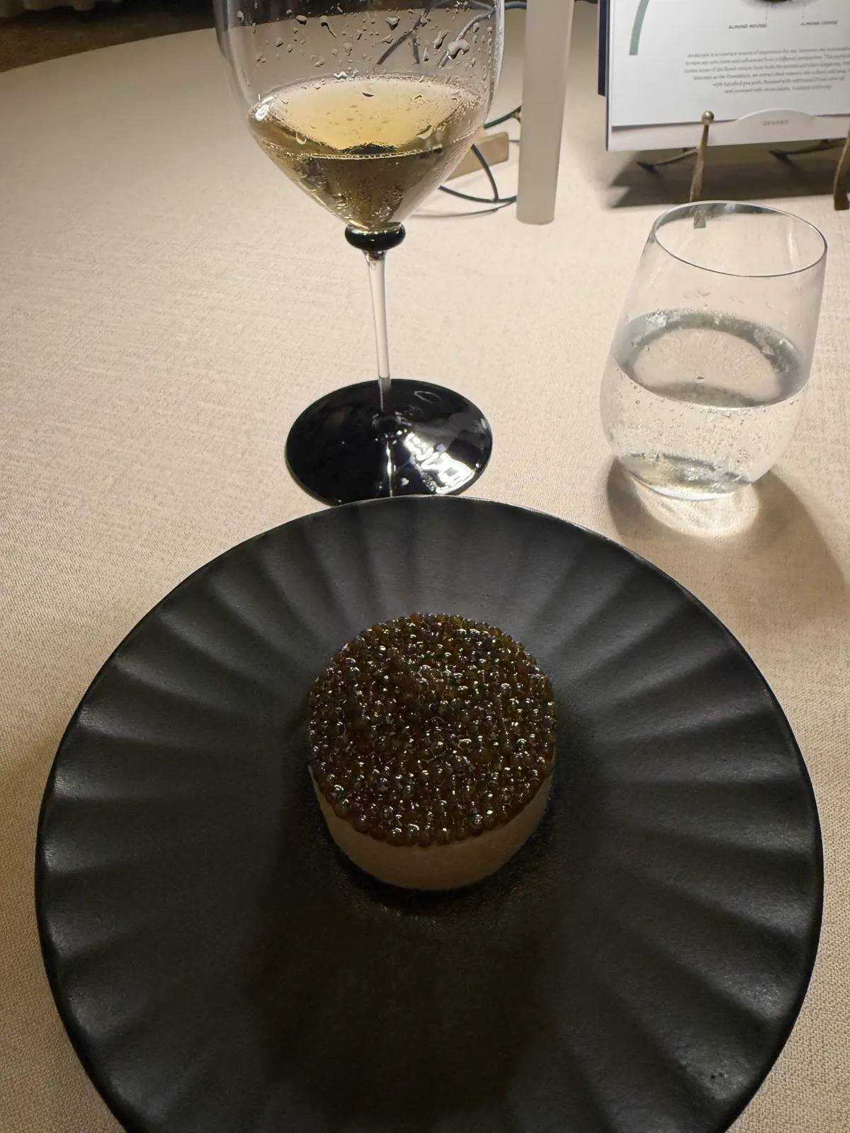 Caviar course at VORO, served on a dark ribbed plate