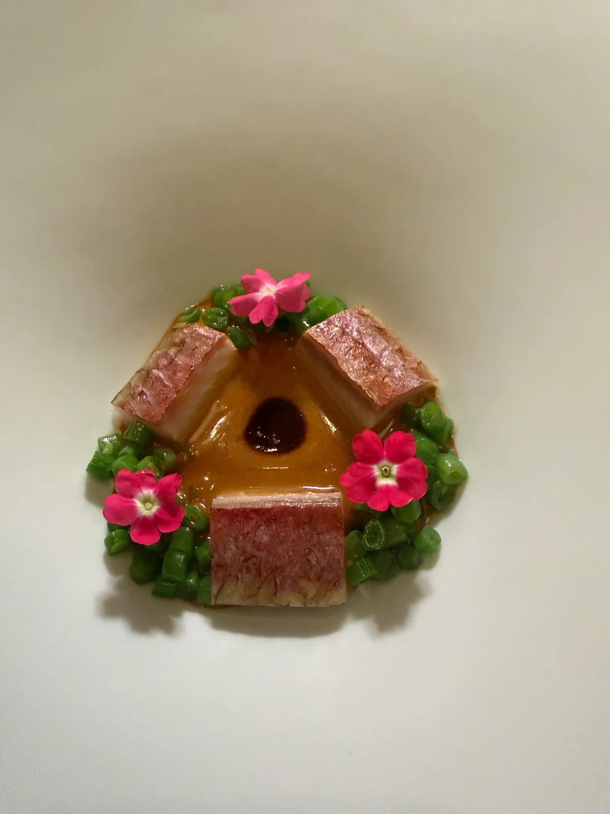 A plated course garnished with flowers